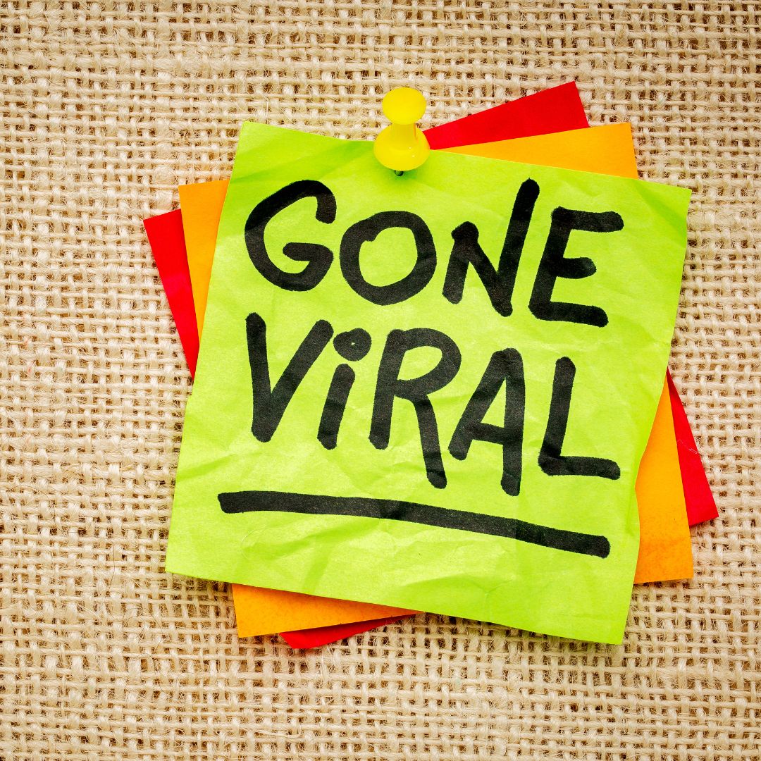 Neon sticky note reading “Gone Viral” pinned on burlap