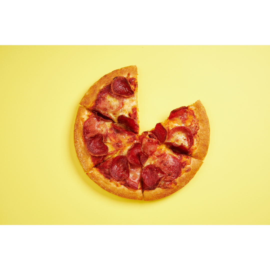 A pepperoni pizza with a missing slice on a bright yellow background, symbolising soemthing may be missing from your marketing.