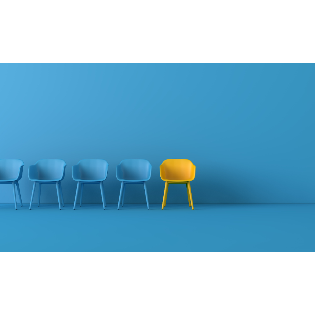 A row of identical blue chairs with one bright yellow chair standing out, symbolising uniqueness and brand differentiation.