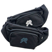 Black canvas waistbags with adjustable straps one with a white logo, the other with a black logo.